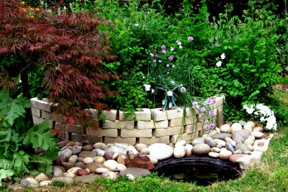 Stone wall planter accented with decorative rock