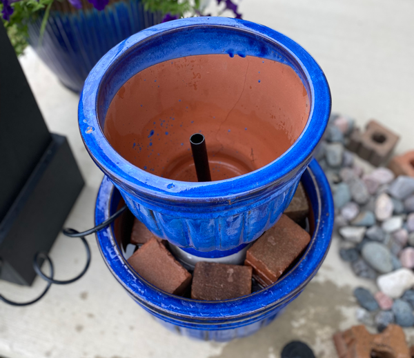 Smaller planter is added to the top of the DIY water fountain