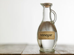 Bottle of white vinegar on a wood table